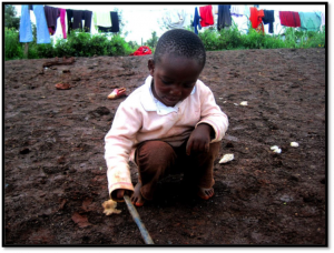 Clinton, age 3, discovering that he can still draw a picture in the dirt with a stick even though he lacks paper and felts.